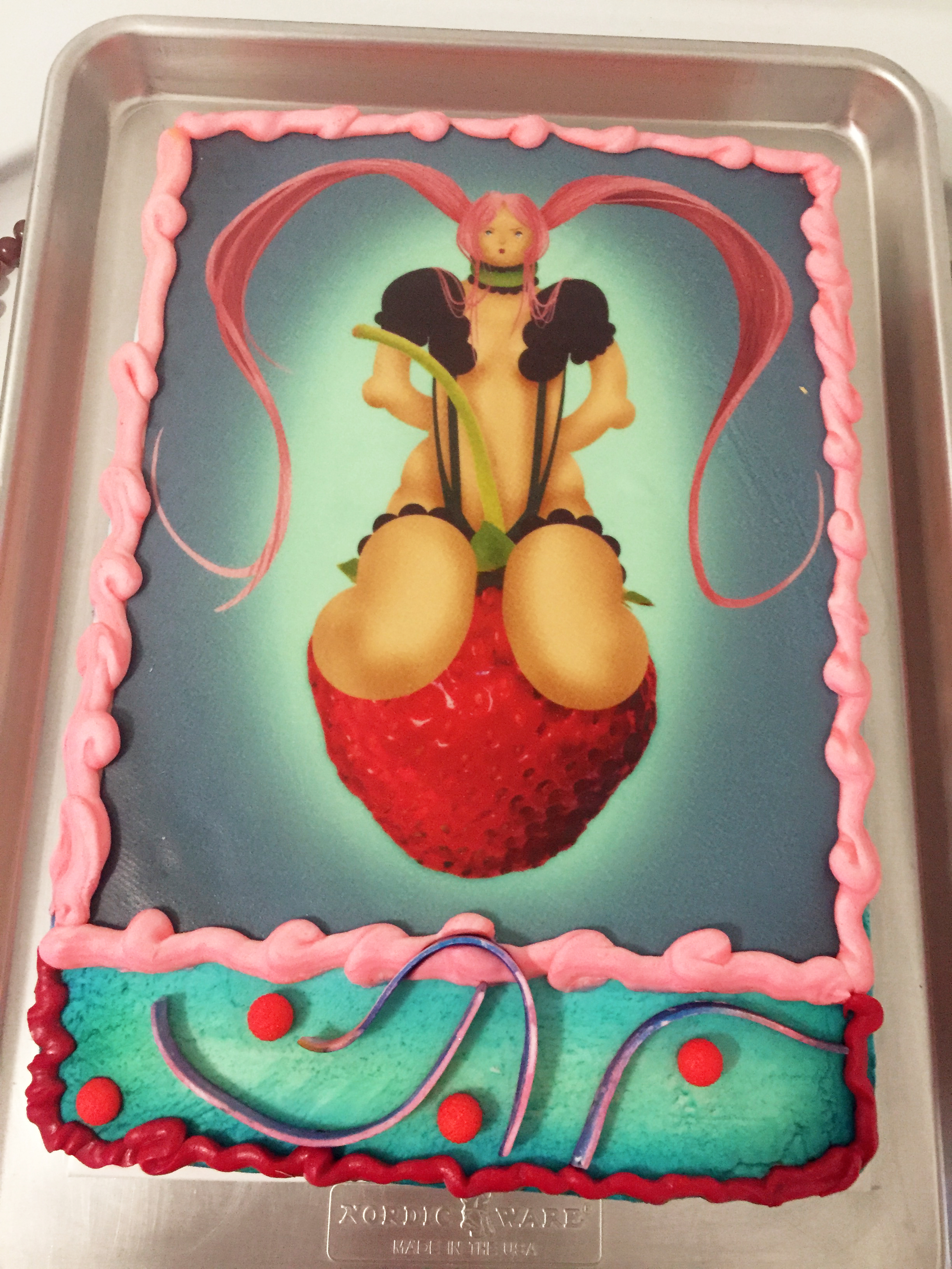 Detail of a cake with an illustration of a girl on it atop a stove